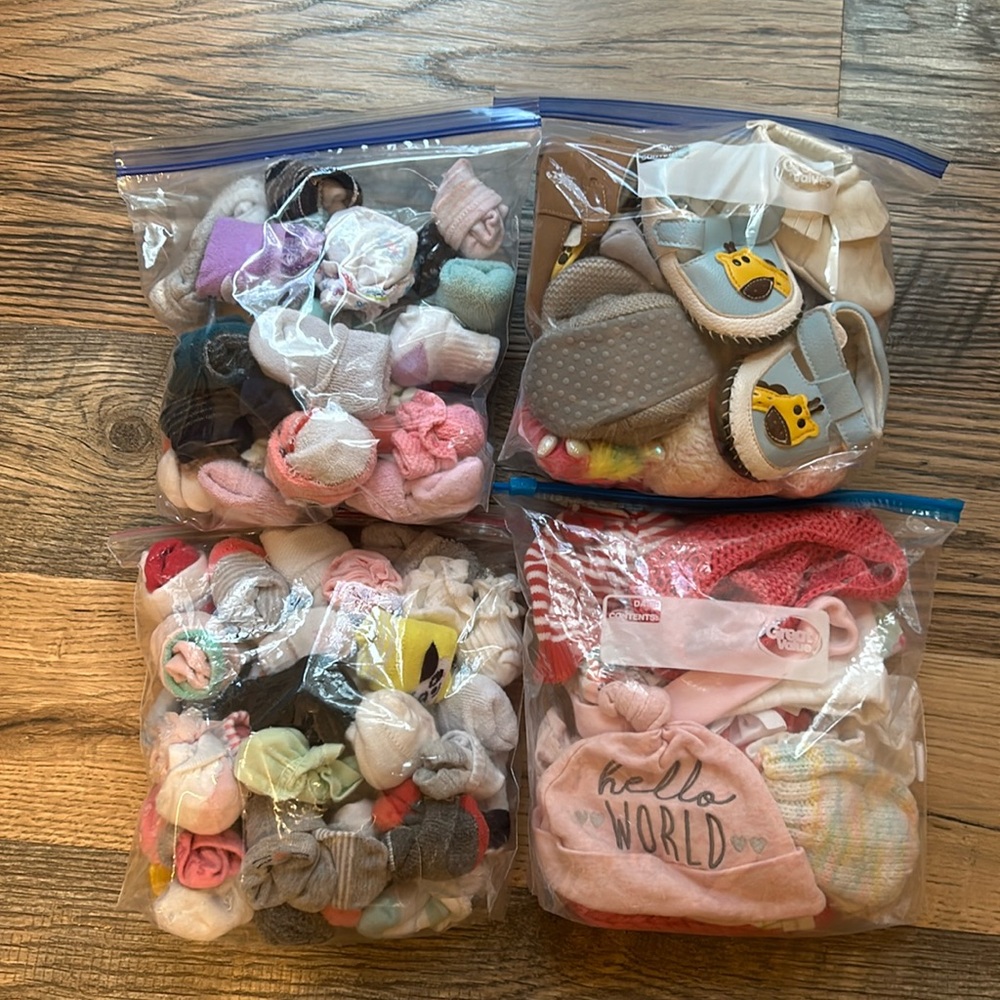 Assorted baby socks, shoes, mittens, and caps